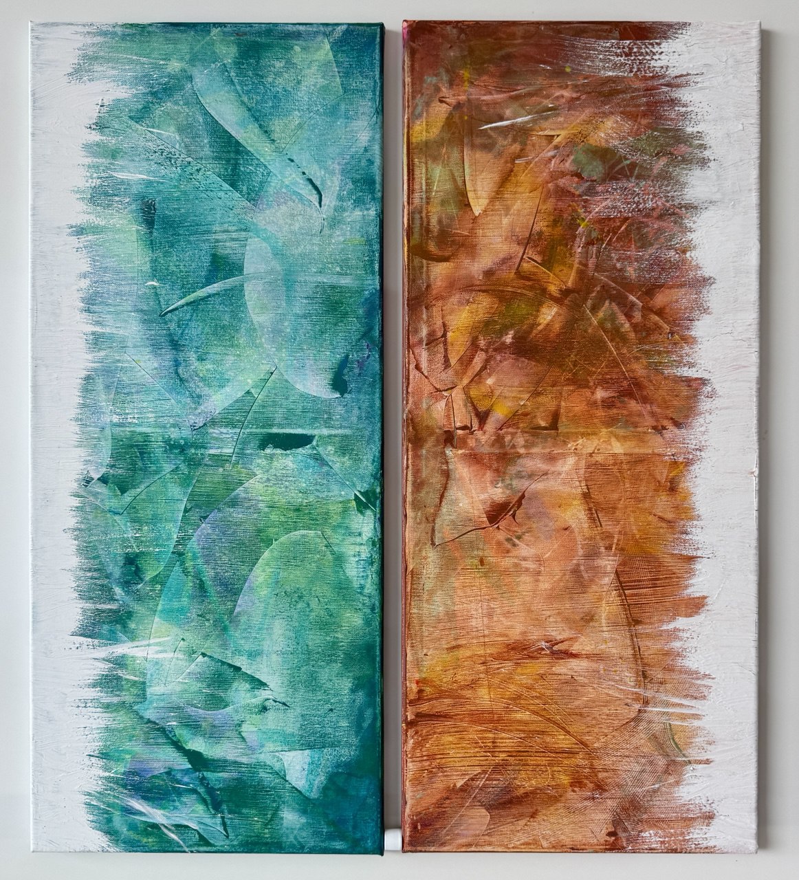 Two tall canvases side by side: layered turquoise-green on the left, layered amber-rust on the right, both with textured brushed edges.